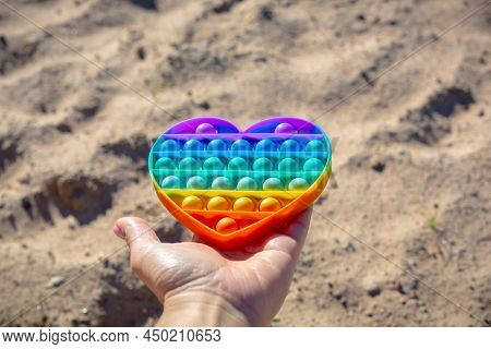 Colorful Antistress Sensory Toy. Pop It Kids Game In Hand. Outdoor Games For Children. Bright Multi-