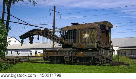 View Of A Rusting Of Train Steam Crane Sitting On A Track Rusting Away On A Sunny Day