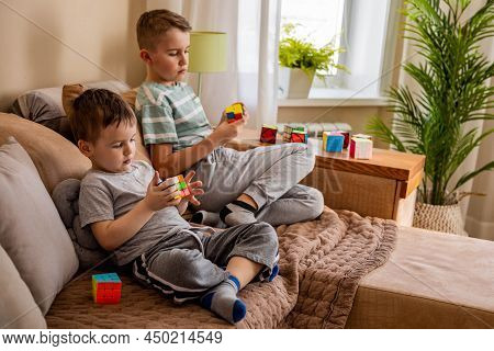 Two Male Kids Brothers Assembling Rubiks Cube Thinking Solving Logic Decision