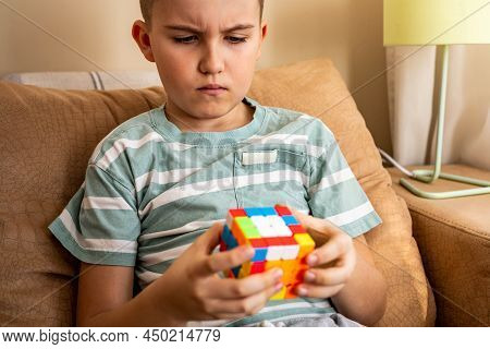 Portrait Frowning Male Teenager Brainstorming Assembling Rubiks Cube Solving Mind Logic Decision