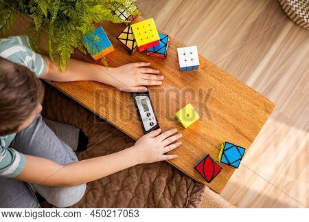 Closeup Top View Male Adolescent Hands Checking Time Of Assembling Rubiks Cube 2x2 Use Timer