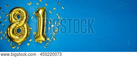 Golden Yellow Foil Balloon On Blue Concrete Background Number Eighty One. Birthday Or Anniversary Ca