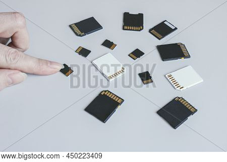 Microsd Memory Card And Hand On The Background Of Other Sd Memory Cards.
