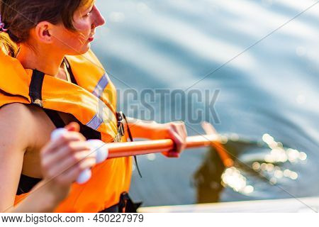 Woman In Life Jacket Sit At Sub Board At River Ar Evening , Forest Trees Background