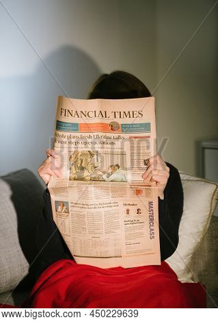 Paris, France - Feb 23, 2022: Woman Reading On The Living Room Couch British Financial Times Newspap