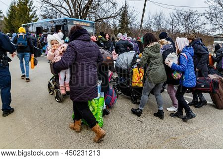 Uzhhorod, Ukraine - February 26, 2022: Ukrainian Refugees With Things Rush To The Slovak Border Flee