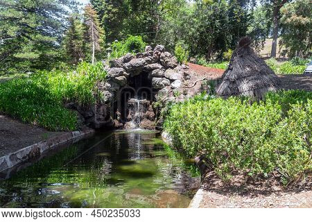 Sao Goncalo, Portugal - August 20, 2021: This Is An Artificial Grotto With A Waterfall On A Stream I
