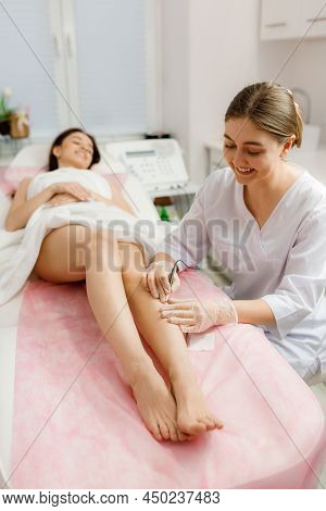Dermatologist Doing Hair Removal Treatment On Patients Leg With Electrolysis. Depilation And Beauty 