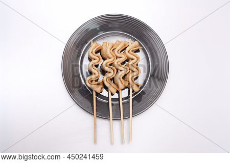 Fish Cake Skewers In A Bowl On A White Background