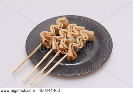 Fish Cake Skewers In A Bowl On A White Background