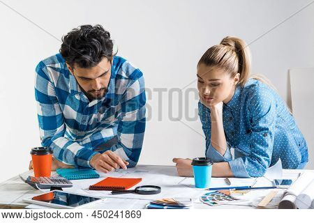 Young Man And Woman Together Working At Design Project. Creative Teamwork At Workspace With Construc