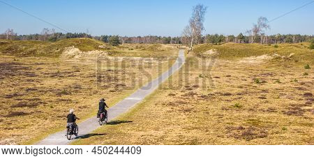 Panorama Of A Senior Couple On Bicycles In The National Park Drents-friese Wold, Netherlands