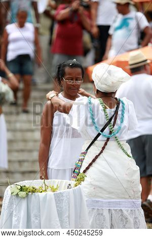 Salvador, Bahia, Brazil - January 25, 2015: Candomble Adept Receives A Spiritual Bath From A Prieste