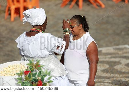 Salvador, Bahia, Brazil - January 25, 2015: Candomble Adept Receives A Spiritual Bath From A Prieste