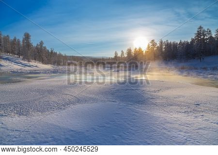 Evening Winter Landscape On A Stream In South Yakutia, Russia. Frazil On The Stream And The Setting 