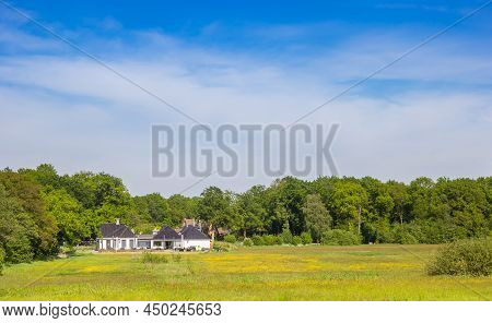 White House In A Field With Yellow Flowers In The Drenste Aa Nature Area In The Netherlands