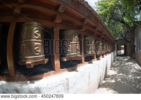 Ladakh , India- May 15,2019 : A Tibetan Prayer Using Brass As A Revolving Instrument To Alchi Monast