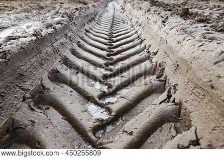 Footprint Of Wheel Tread On The Ground Road. The Trail From The Tread Of Trucks Wheels. Car Tire Tre