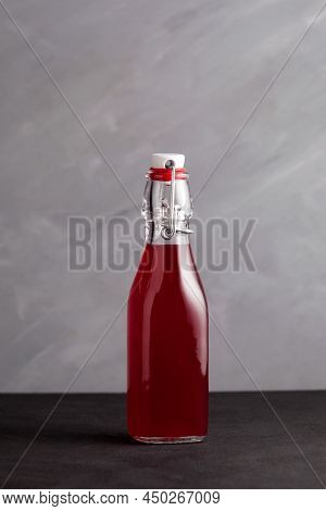 Homemade Fermented Healthy Drink In Glass Bottle. Grey Background, Vertical Orientation, Copy Space.