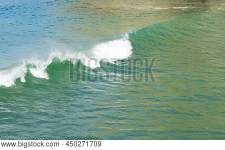 Surf Waves With White Water Crests Rolling In At Tolaga Bay, New Zealand.