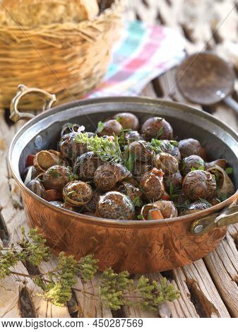 A Traditional Greek Recipe From Crete ,baked Snails With Garlic Butter And Herbs