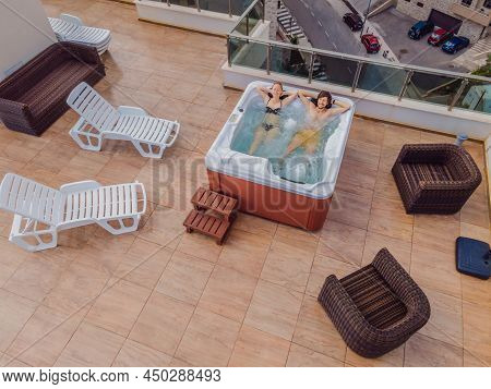 Drone View. Portrait Of Young Carefree Happy Smiling Couple Relaxing At Hot Tub During Enjoying Happ