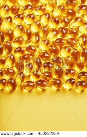 Capsules In A Shell With Liquid Vitamin D3 On A Yellow Background And A Place For Text