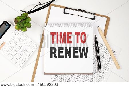 Office Desk Table With Paper Sheet, Notepad ,chart And Calculator. Top View Text Time To Renew