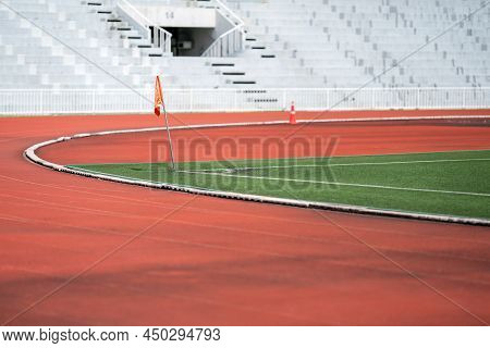 A Red Flag Corner In Soccer Area With Track Field For Athletes, Runner, Sports Players, And Students