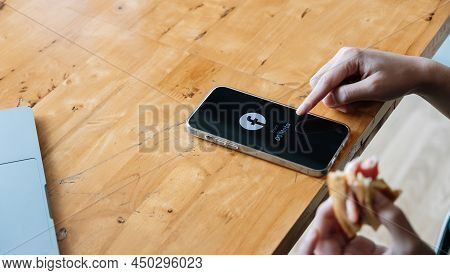 Chiang Mai. Thailand. Feb 26, 2022. A Woman Holds Apple Iphone 13 With Facebook Logo On The Screen F