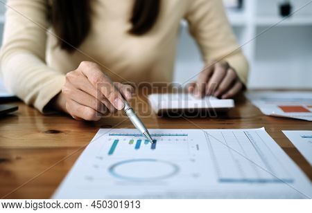 Finance Business People Or Accountants Point To The Graph And Use A Calculator To Calculate Company 