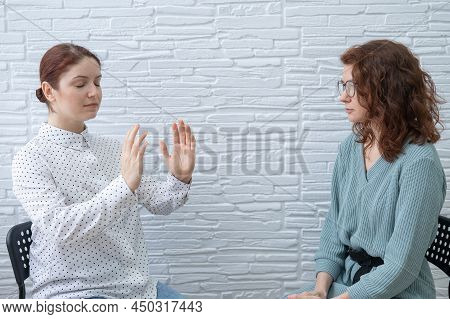 The Psychotherapist Conducts A Hypnosis Session. Female Patient Under Hypnosis.