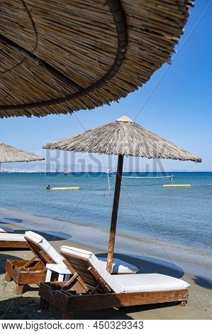 Beach Unbrellas And Chairs On Sunny Sandy Beach Lady's Mile In Akritori, Cyprus
