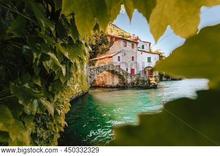 Nesso, Italy - May 2021: Village Of Nesso With The Medieval Bridge, Also Called Civera Bridge, On La