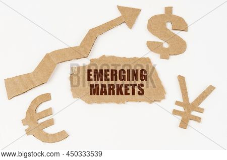 Economic Concept. On A White Background, Symbols Of The Dollar, Euro, Yen, An Arrow Pointing Up And 