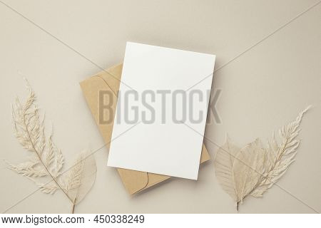 Blank Greeting Card Invitation Mockup 5x7 On Brown Envelope With Dried Flowers On Beige Background, 