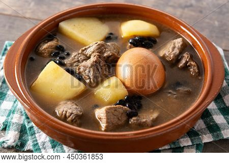 Traditional Jewish Cholent In Bowl On Wooden Table
