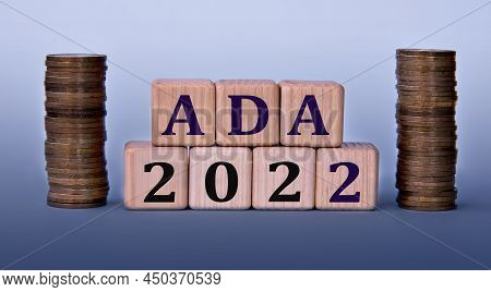 Ada 2022 - Acronym On Wooden Cubes On A Light Background With Coins.