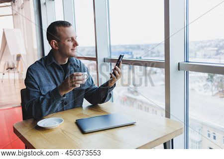 Happy Smiling Male Manager Sitting In Cafe Using Mobile Phone Gadget, Ordering Delivery Service Via