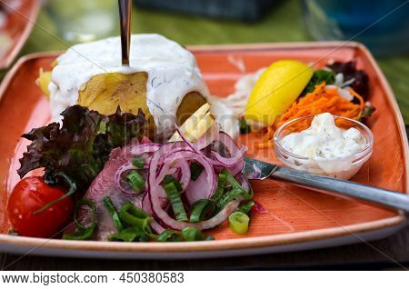 A Plate With Delicious Maties, Onions, Lettuce Lemons And Potatoes.