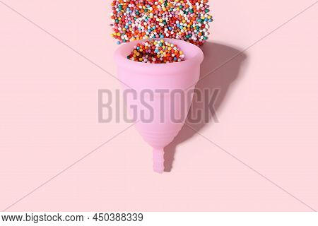 Pink Menstrual Cup And Bright Beads Like Blood Drop With Shadow On Pink Background. Women's Health, 
