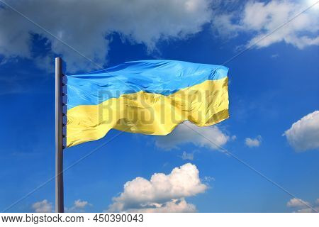 Ukrainian Flag Against The Background Of The Sky With Clouds
