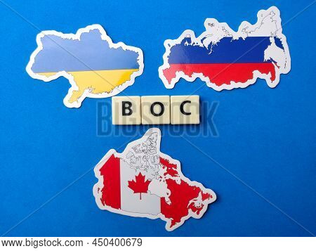 Top View Canada,russia And Ukraine Flag With Text Boc On Blue Background.