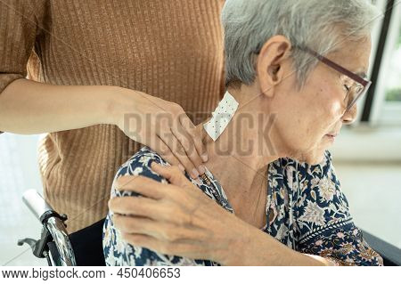 Asian Senior Mother Have Nerve Pain,shoulder Ache,neck Pains,female Caregiver Or Daughter Massaging 