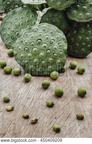 Fresh Green Lotus Seed Pods And Lotus Seeds Green On Old Wooden Board Background. Selective Focus.