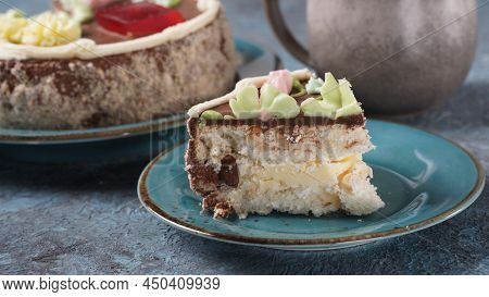 Piece Of Kyiv Cake With Chocolate Cream And Decorated Top On Blue Plate