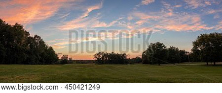 Panorama Image Of Sunset Over Open Field