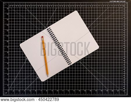 Notepad With Pencil On Black Cutting Mat, Copy Space