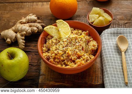 Couscous Masfouf With Dried Fruits And Nuts On A Linen Napkin Next To A Spoon And Fresh Fruit. Horiz