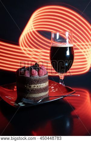 Chocolate stout beer with chocolate cake and raspberries